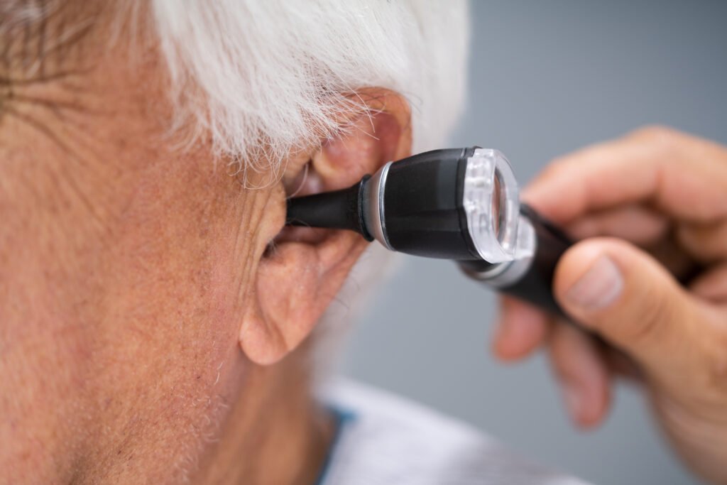 pharmacist checking patients ear