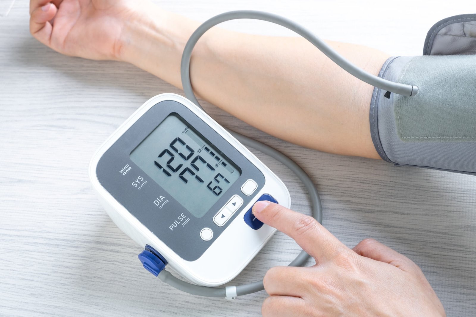 Digital blood pressure monitor connected to an upper-arm cuff