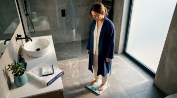 Woman checking weight on bathroom scale