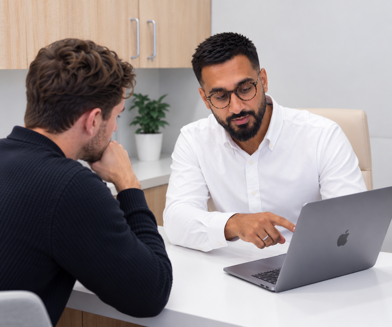 Pharmacist prescriber discussing testosterone replacement therapy with a patient during a private TRT consultation at Puri Pharmacy.