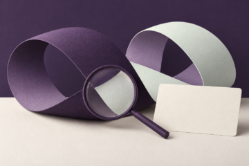 Magnifying glass over folded paper loops illustrating scrutiny of peptide research claims.