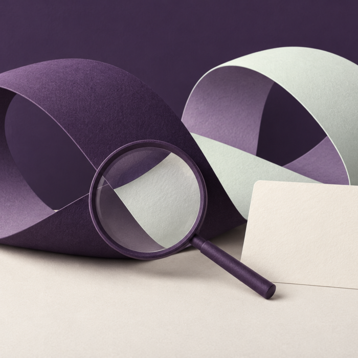 Magnifying glass over folded paper loops illustrating scrutiny of peptide research claims.
